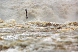 Man crossing the Mekong on a rope bridge